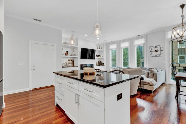1359 W Fullerton Ave Unit 2E, Chicago, IL 60614 - kitchen featuring dark countertops, dark wood-style flooring, crown molding, white cabinets, and decorative light fixtures