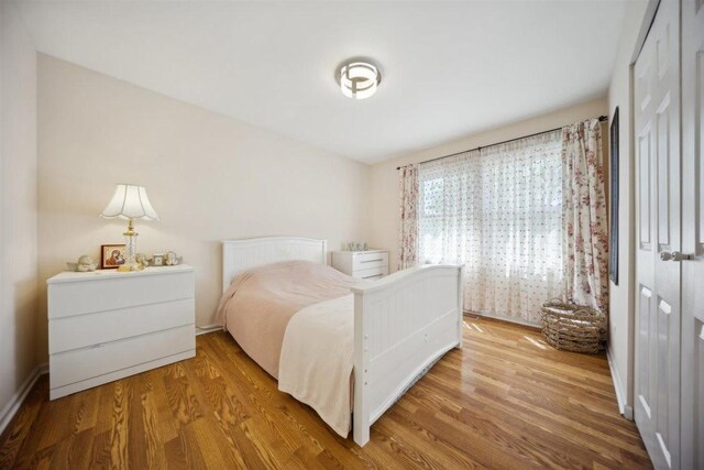 2121 Pepperwood Ln Unit 0, Glendale Heights, IL 60139 - bedroom with wood finished floors and a closet