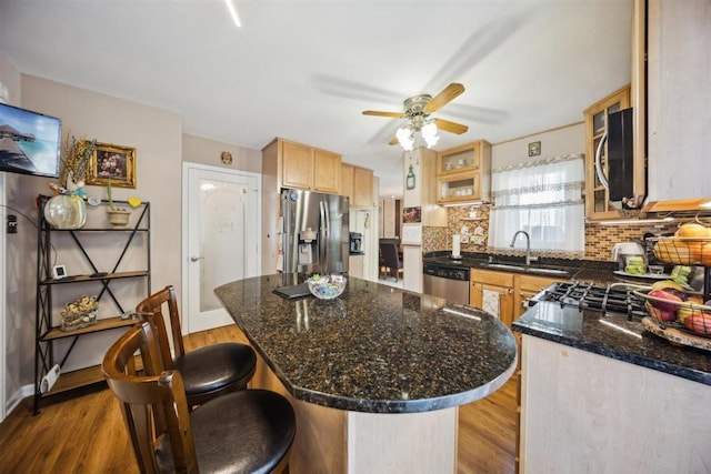 2121 Pepperwood Ln Unit 0, Glendale Heights, IL 60139 - kitchen with stainless steel appliances, a sink, ceiling fan, decorative backsplash, and wood finished floors