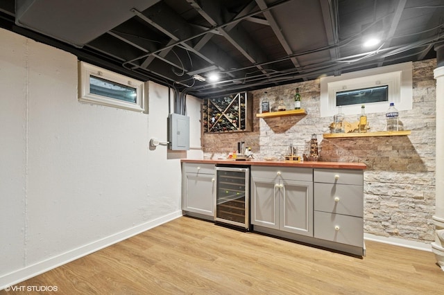 431 Elm Ave, Geneva, IL 60134 - indoor wet bar featuring beverage cooler, electric panel, light wood-style flooring, and baseboards