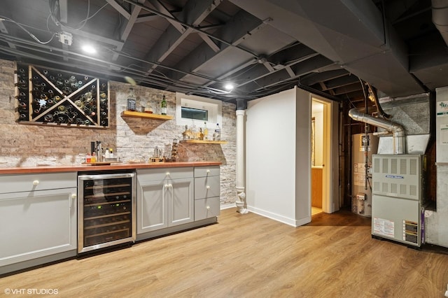 431 Elm Ave, Geneva, IL 60134 - indoor bar featuring wine cooler, gas water heater, light wood-style floors, and heating unit