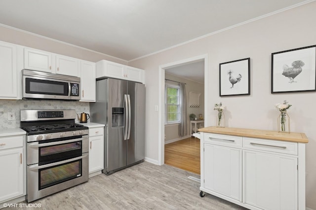 431 Elm Ave, Geneva, IL 60134 - kitchen with appliances with stainless steel finishes, light wood-style floors, crown molding, tasteful backsplash, and white cabinetry
