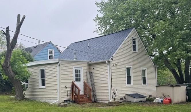 1623 Beverly Dr, Round Lake Beach, IL 60073 - rear view of property with entry steps, a shingled roof, and a yard