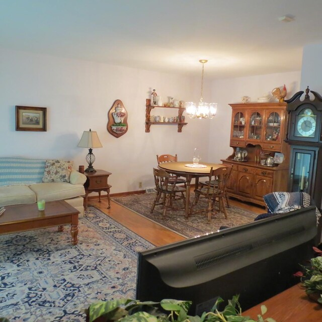 206 Vermont St, Momence, IL 60954 - living room featuring wood finished floors and a chandelier
