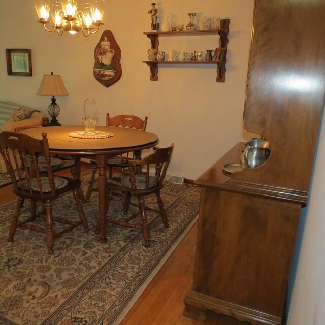 206 Vermont St, Momence, IL 60954 - dining space with wood finished floors and a chandelier