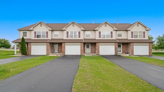 677 Southtowne Dr Unit 1, Belvidere, IL 61008 - townhome / multi-family property featuring a garage, brick siding, driveway, a front yard, and a shingled roof