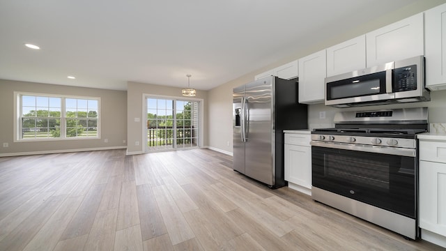 677 Southtowne Dr Unit 1, Belvidere, IL 61008 - kitchen with appliances with stainless steel finishes, light wood-type flooring, baseboards, white cabinetry, and recessed lighting