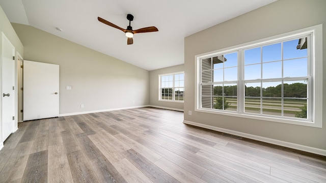 677 Southtowne Dr Unit 1, Belvidere, IL 61008 - empty room featuring lofted ceiling, a ceiling fan, wood finished floors, and baseboards
