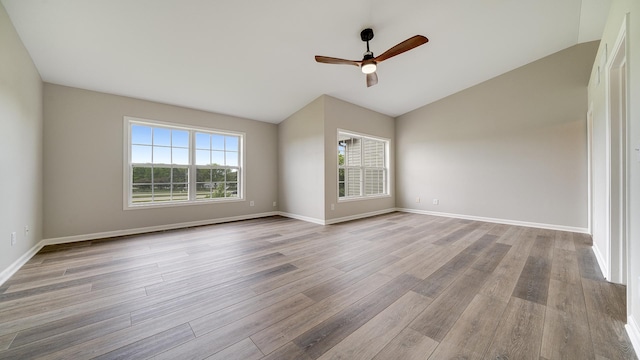677 Southtowne Dr Unit 1, Belvidere, IL 61008 - unfurnished room featuring vaulted ceiling, a ceiling fan, wood finished floors, and baseboards