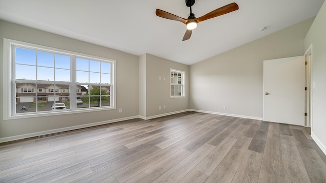 677 Southtowne Dr Unit 1, Belvidere, IL 61008 - empty room featuring a ceiling fan, wood finished floors, vaulted ceiling, and baseboards