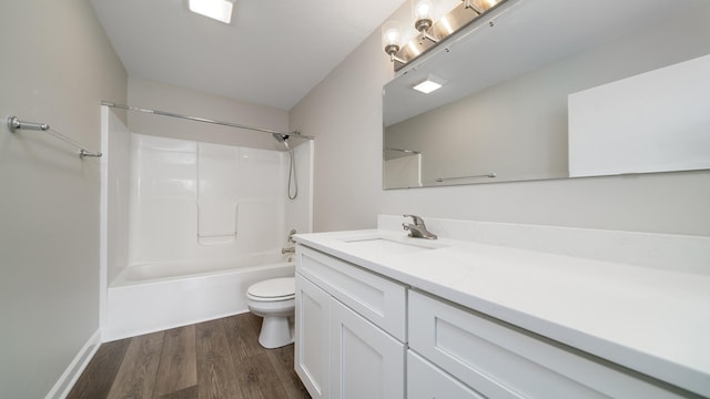 677 Southtowne Dr Unit 1, Belvidere, IL 61008 - bathroom featuring toilet, wood finished floors, vanity, and  shower combination