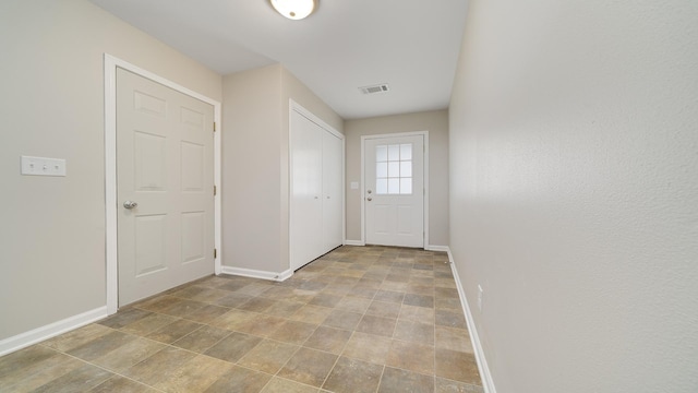 677 Southtowne Dr Unit 1, Belvidere, IL 61008 - doorway to outside featuring baseboards