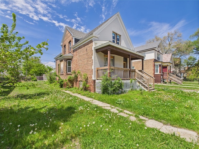 8432 S Sangamon St, Chicago, IL 60620 - view of property exterior featuring a porch, brick siding, stairs, and a yard