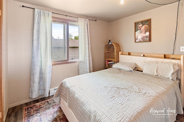 125 E Second S St, Chebanse, IL 60922 - bedroom with wood finished floors, a baseboard heating unit, and baseboards