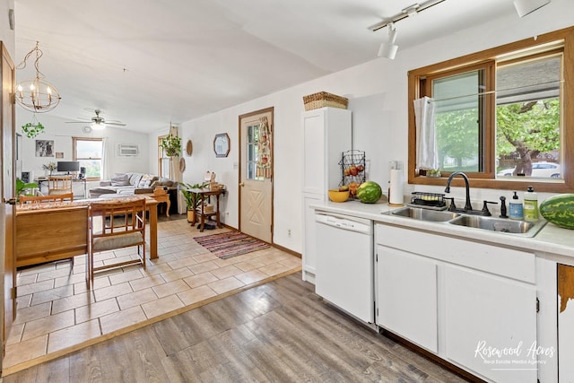 125 E Second S St, Chebanse, IL 60922 - kitchen with white dishwasher, a sink, light countertops, light wood-style flooring, and white cabinets