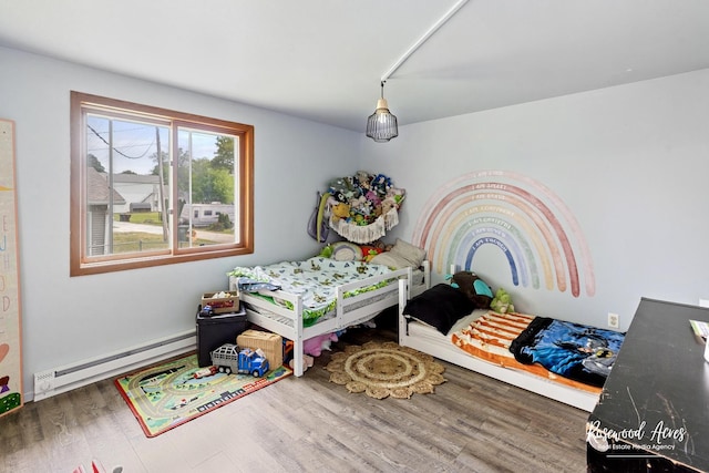 125 E Second S St, Chebanse, IL 60922 - bedroom with a baseboard heating unit and wood finished floors
