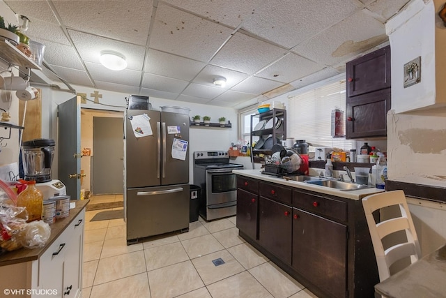 5351 N Kimball Ave, Chicago, IL 60625 - kitchen with stainless steel appliances, a paneled ceiling, light tile patterned floors, and a sink