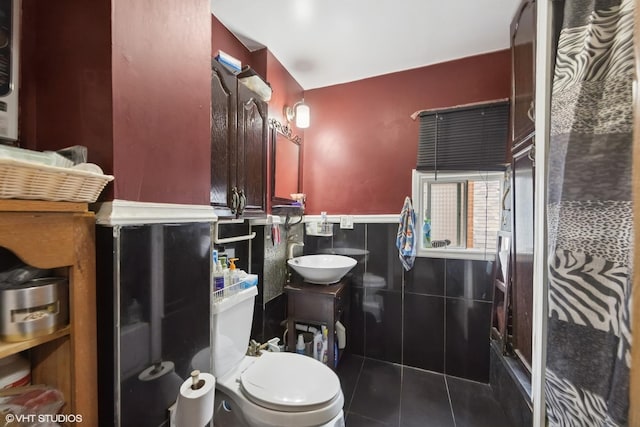 5351 N Kimball Ave, Chicago, IL 60625 - bathroom with tile walls, a sink, a wainscoted wall, tile patterned floors, and toilet