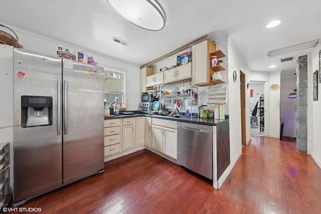 5351 N Kimball Ave, Chicago, IL 60625 - kitchen featuring stainless steel appliances, dark countertops, cream cabinets, dark wood-style flooring, and open shelves