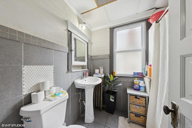 5351 N Kimball Ave, Chicago, IL 60625 - bathroom featuring tile walls, tile patterned floors, toilet, crown molding, and a sink