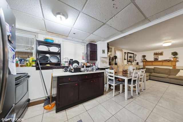 5351 N Kimball Ave, Chicago, IL 60625 - kitchen with range with electric cooktop, freestanding refrigerator, a drop ceiling, light tile patterned floors, and light countertops