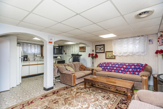 5938 W 83rd St, Burbank, IL 60459 - living room featuring a paneled ceiling, arched walkways, and light flooring