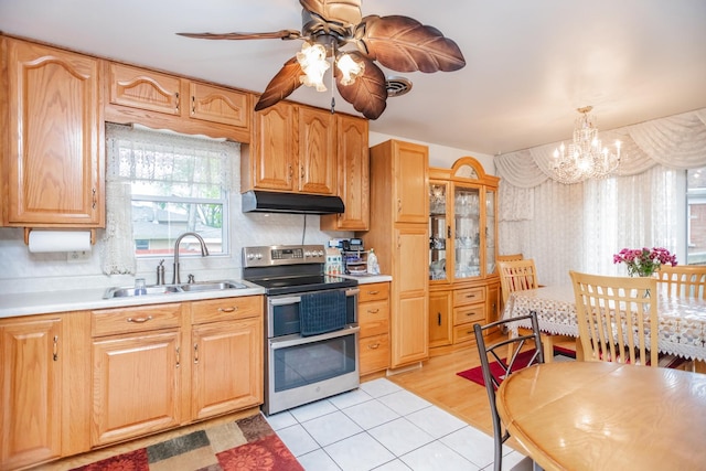 5938 W 83rd St, Burbank, IL 60459 - kitchen with range with two ovens, a sink, under cabinet range hood, a chandelier, and light countertops