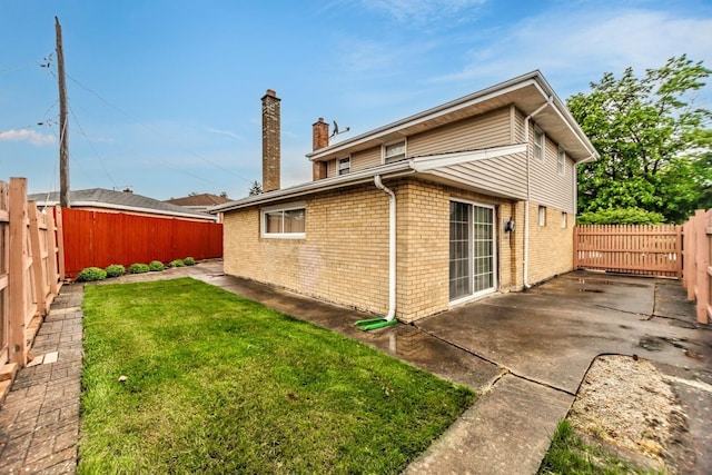 5938 W 83rd St, Burbank, IL 60459 - rear view of house with a chimney, brick siding, and a patio