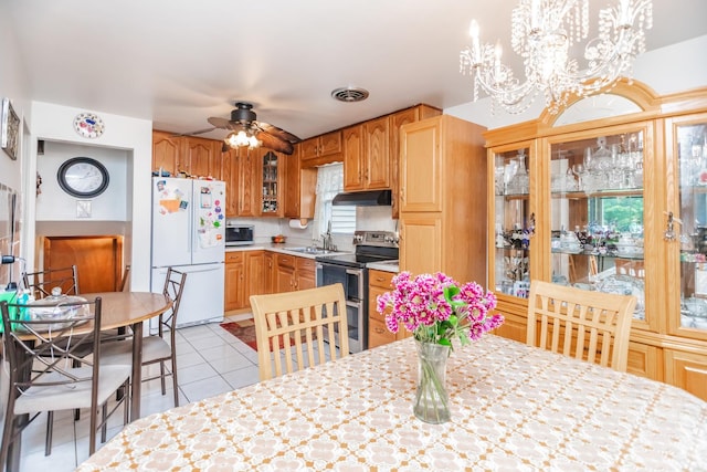 5938 W 83rd St, Burbank, IL 60459 - kitchen featuring appliances with stainless steel finishes, under cabinet range hood, light tile patterned floors, ceiling fan, and a sink