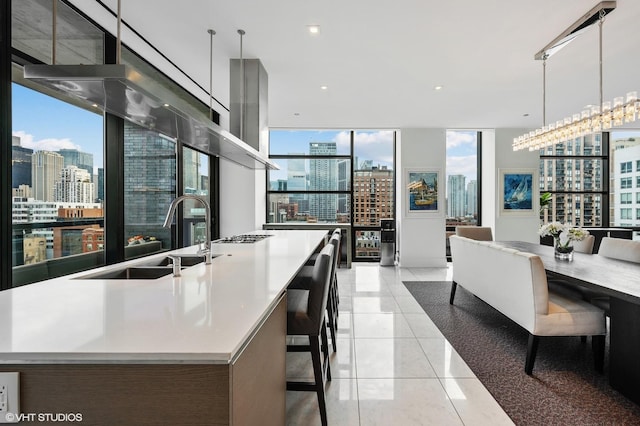 400 W Huron St Unit 1001, Chicago, IL 60654 - kitchen featuring a sink, a city view, light tile patterned floors, floor to ceiling windows, and decorative light fixtures