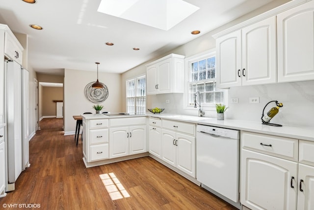 2028 Creekside Dr, Wheaton, IL 60189 - kitchen featuring dishwasher, a sink, a skylight, a peninsula, and recessed lighting