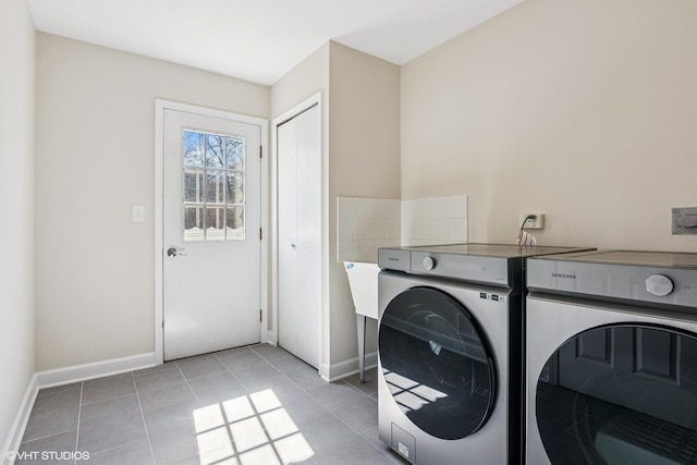2028 Creekside Dr, Wheaton, IL 60189 - washroom featuring washing machine and clothes dryer, baseboards, and light tile patterned floors