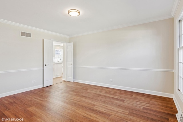 2028 Creekside Dr, Wheaton, IL 60189 - unfurnished room featuring ornamental molding, light wood finished floors, baseboards, and a sink