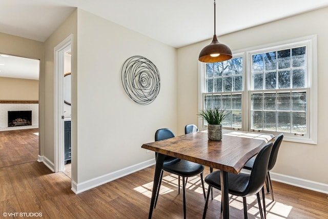 2028 Creekside Dr, Wheaton, IL 60189 - dining space with wood finished floors, baseboards, and a brick fireplace