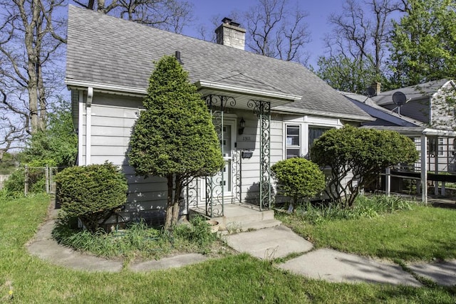 1311 Eastview Dr, Waukegan, IL 60085 - view of front of house featuring a chimney and roof with shingles