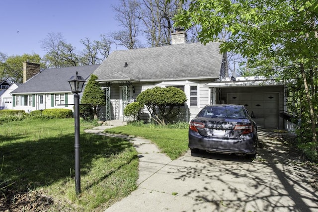 1311 Eastview Dr, Waukegan, IL 60085 - view of front of property featuring a chimney, driveway, a garage, and a front yard