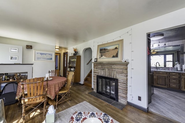 1311 Eastview Dr, Waukegan, IL 60085 - dining room with dark wood-style floors, a fireplace, and stairway