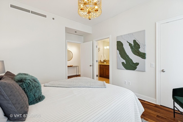 340 E Randolph St Unit 4806, Chicago, IL 60601 - bedroom featuring wood finished floors, a chandelier, baseboards, and connected bathroom