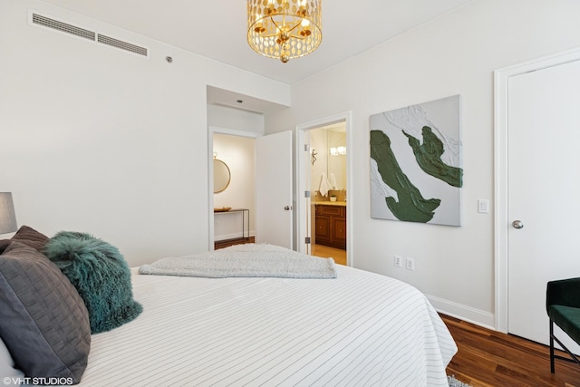 340 E Randolph St Unit 4806, Chicago, IL 60601 - bedroom featuring wood finished floors, a chandelier, baseboards, and connected bathroom