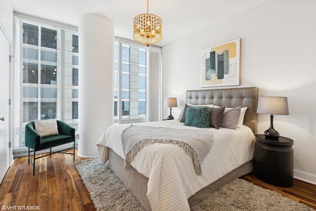 340 E Randolph St Unit 4806, Chicago, IL 60601 - bedroom featuring a chandelier, wood finished floors, and floor to ceiling windows
