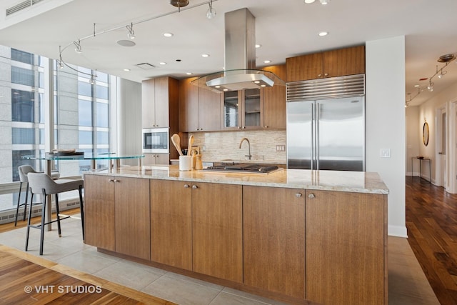 340 E Randolph St Unit 4806, Chicago, IL 60601 - kitchen featuring stainless steel appliances, rail lighting, tasteful backsplash, and light stone counters