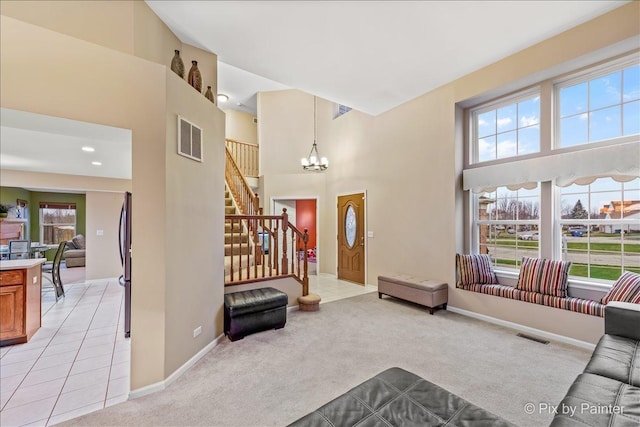 553 S Haverhill Ln, South Elgin, IL 60177 - entrance foyer featuring a chandelier, light carpet, stairway, baseboards, and a towering ceiling