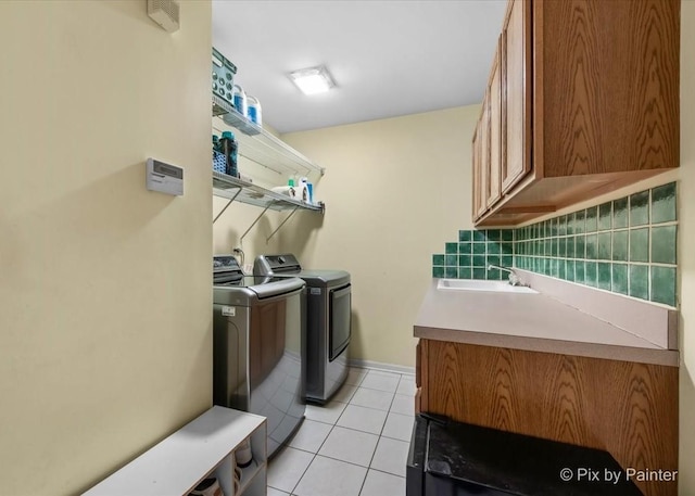553 S Haverhill Ln, South Elgin, IL 60177 - laundry area featuring cabinet space, washer and clothes dryer, light tile patterned floors, and baseboards