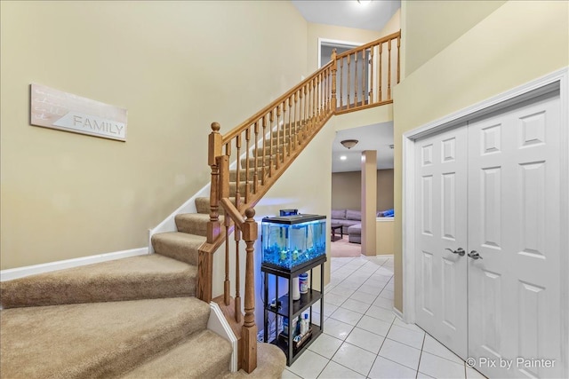 553 S Haverhill Ln, South Elgin, IL 60177 - stairs featuring tile patterned flooring, carpet, a towering ceiling, and baseboards