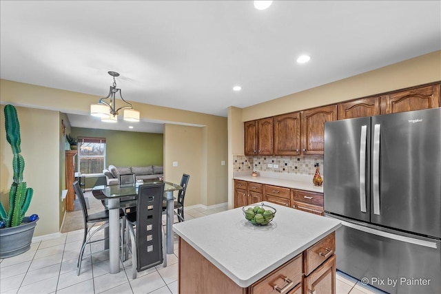 553 S Haverhill Ln, South Elgin, IL 60177 - kitchen with freestanding refrigerator, light countertops, decorative light fixtures, backsplash, and light tile patterned floors