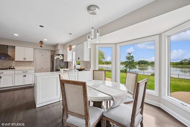 4141 Rutgers Ln, Northbrook, IL 60062 - dining space featuring a water view, dark wood-style floors, recessed lighting, and baseboards
