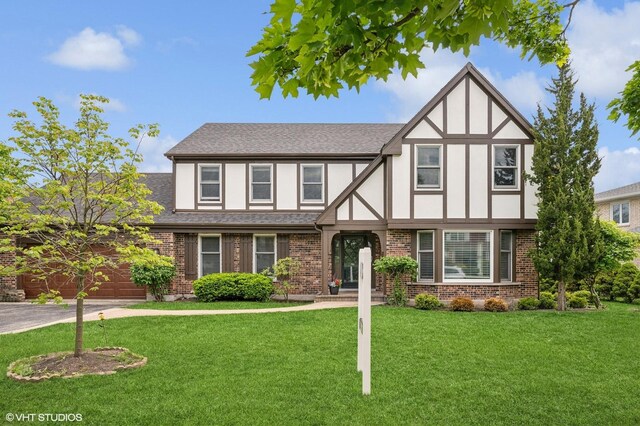 4141 Rutgers Ln, Northbrook, IL 60062 - english style home with brick siding, a front yard, stucco siding, and a shingled roof