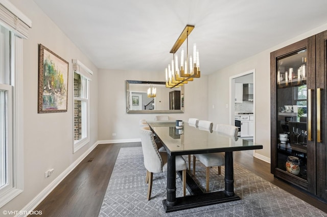 4141 Rutgers Ln, Northbrook, IL 60062 - dining space featuring dark wood-style flooring, a chandelier, and baseboards