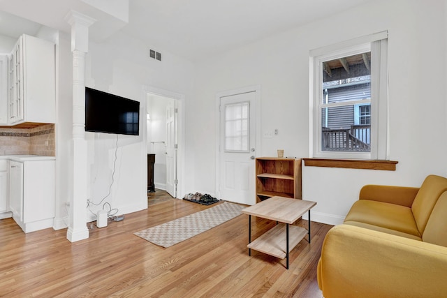 918 W 35th Pl, Chicago, IL 60609 - living room with light wood-style flooring, baseboards, and ornate columns