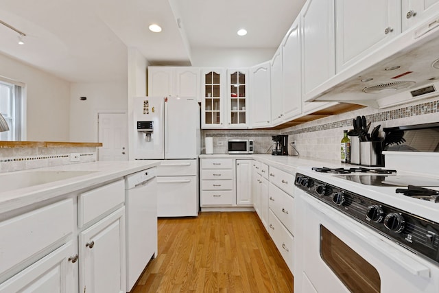 918 W 35th Pl, Chicago, IL 60609 - kitchen with white appliances, tasteful backsplash, light wood-style floors, light countertops, and white cabinets